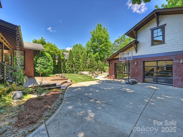 view of patio / terrace with driveway and a garage