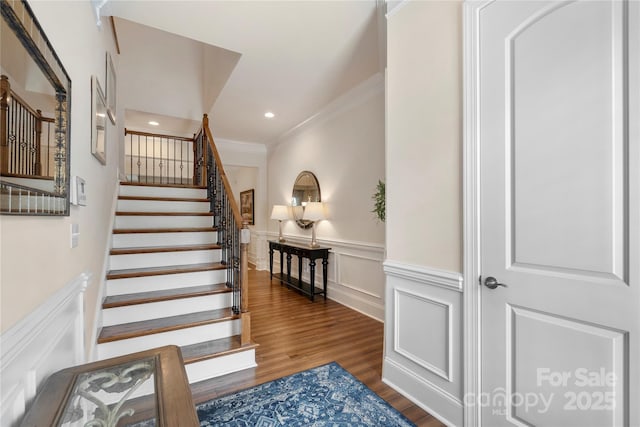 5422 Shannon Bell Ln, Charlotte, NC 28277 - stairs with ornamental molding, a decorative wall, wood finished floors, wainscoting, and recessed lighting