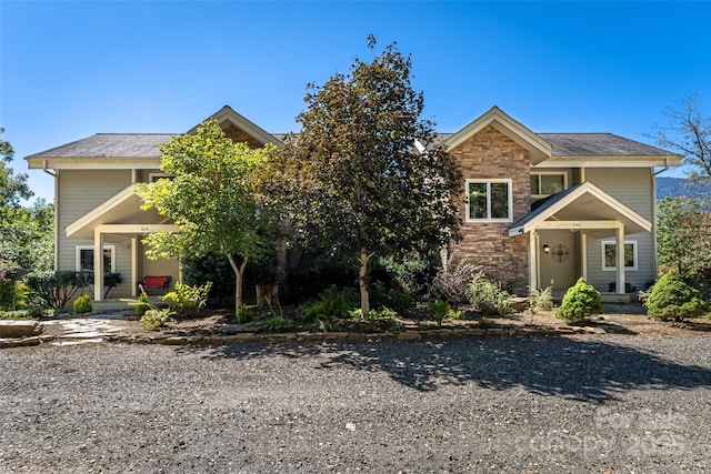 view of front of home with stone siding and a porch