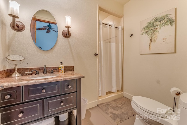 full bath with a stall shower, vanity, toilet, and tile patterned floors