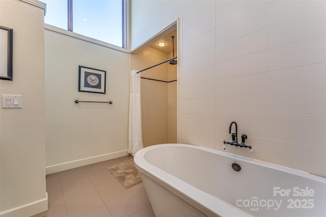 full bathroom featuring a soaking tub, a shower with shower curtain, and tile patterned flooring