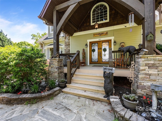 doorway to property with a porch and french doors