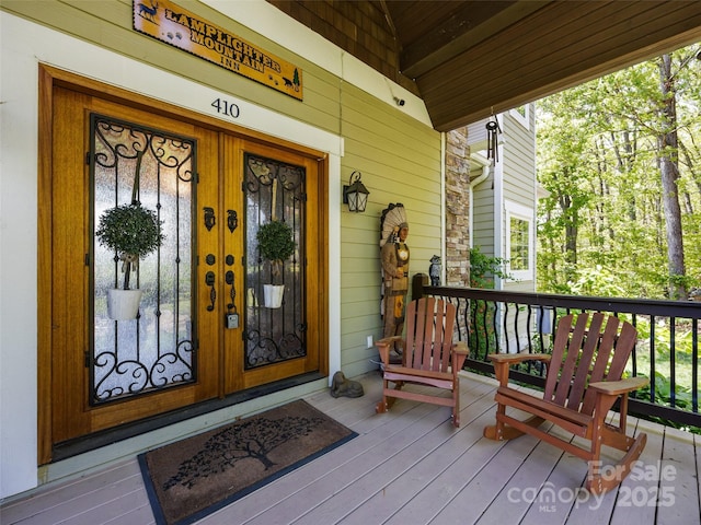 property entrance featuring french doors and a porch