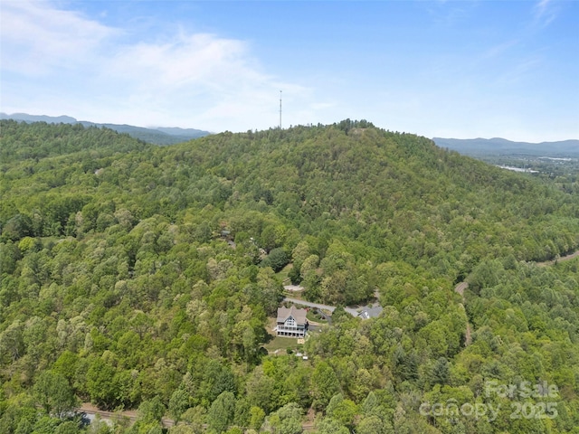 drone / aerial view featuring a wooded view