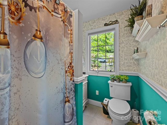 bathroom with toilet and wallpapered walls
