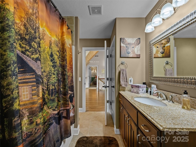 full bathroom featuring visible vents, vanity, baseboards, tile patterned floors, and french doors