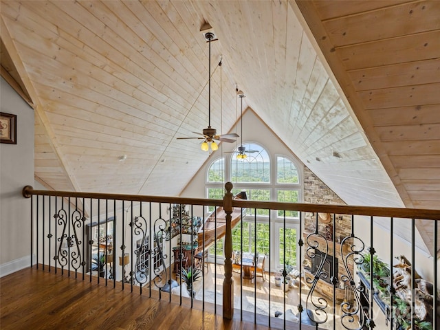 interior space with baseboards, wood ceiling, wood finished floors, and vaulted ceiling