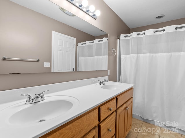bathroom featuring double vanity, a sink, tile patterned floors, and a shower with curtain
