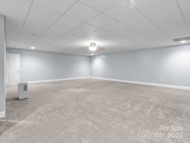 basement with baseboards, carpet flooring, a paneled ceiling, and recessed lighting