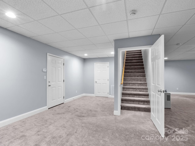 finished basement featuring baseboards, a drop ceiling, stairway, recessed lighting, and carpet flooring