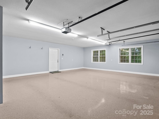 garage with baseboards and a garage door opener