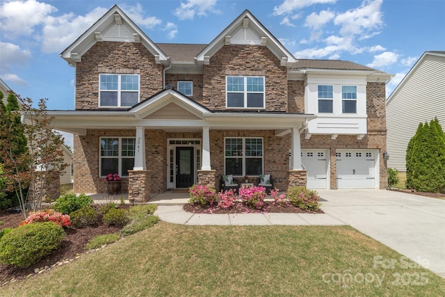 craftsman inspired home featuring a front lawn, an attached garage, stone siding, concrete driveway, and a porch