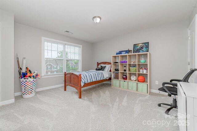 bedroom with visible vents, carpet, and baseboards