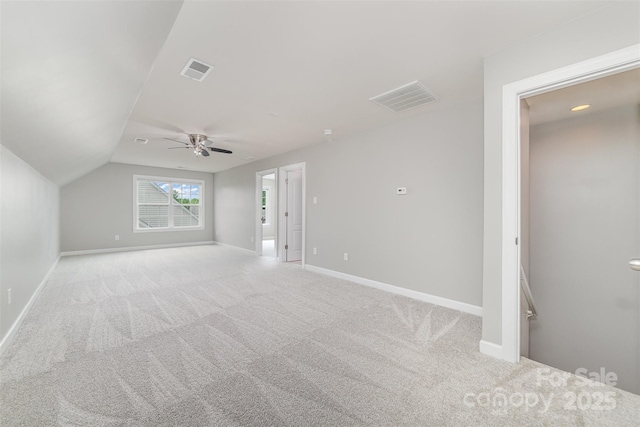 interior space with visible vents, baseboards, and light carpet