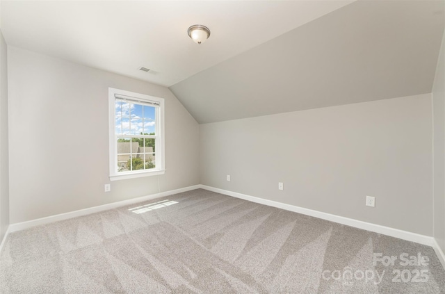 additional living space featuring baseboards, carpet, and visible vents