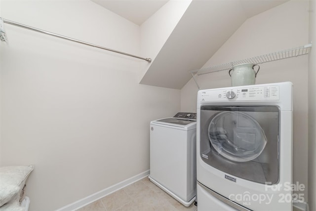 clothes washing area featuring laundry area, baseboards, independent washer and dryer, and light tile patterned floors