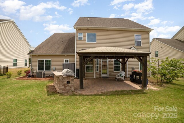 rear view of property featuring a patio, a gazebo, a yard, and central AC unit