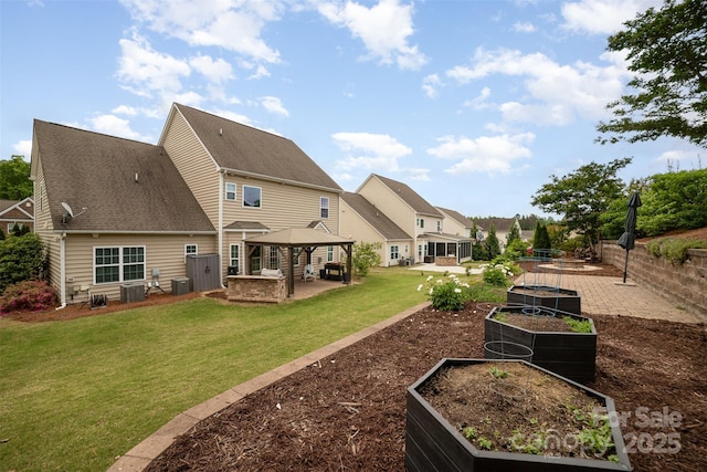 back of house featuring a garden, a lawn, cooling unit, a patio, and a gazebo