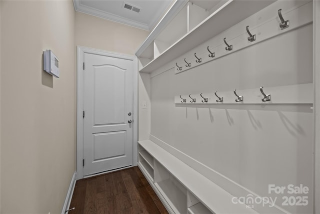 mudroom with crown molding, baseboards, dark wood-type flooring, and visible vents