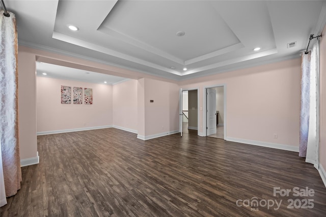unfurnished room with crown molding, recessed lighting, a tray ceiling, and dark wood-type flooring