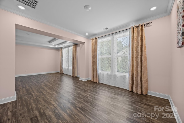 unfurnished room with visible vents, ornamental molding, baseboards, and wood finished floors