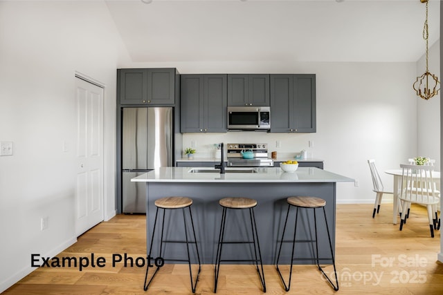 4 Chestnut Ridge Ave, Asheville, NC 28804 - kitchen with light countertops, stainless steel appliances, a sink, and a kitchen bar
