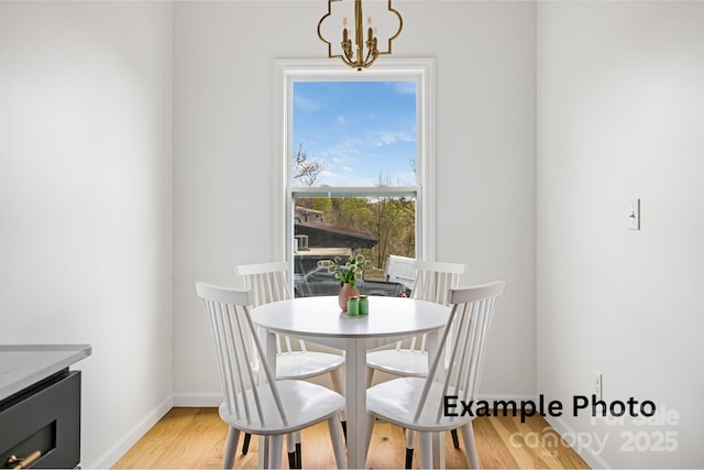 4 Chestnut Ridge Ave, Asheville, NC 28804 - dining space with light wood-style floors, baseboards, and an inviting chandelier