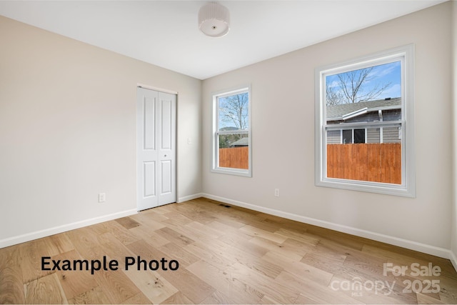 4 Chestnut Ridge Ave, Asheville, NC 28804 - unfurnished room featuring baseboards, wood finished floors, and visible vents