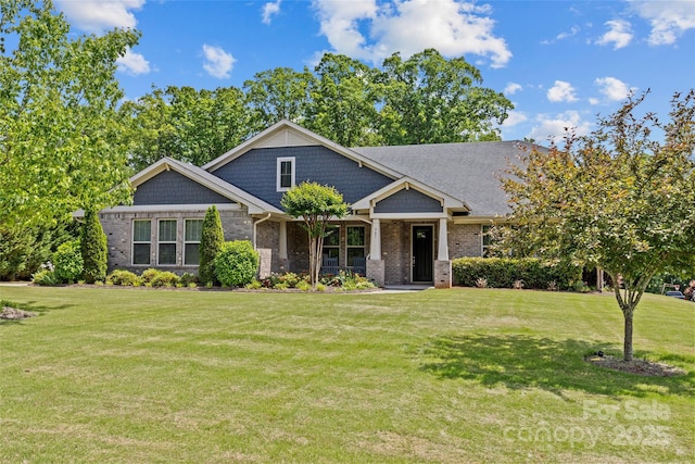 craftsman-style house featuring brick siding and a front lawn