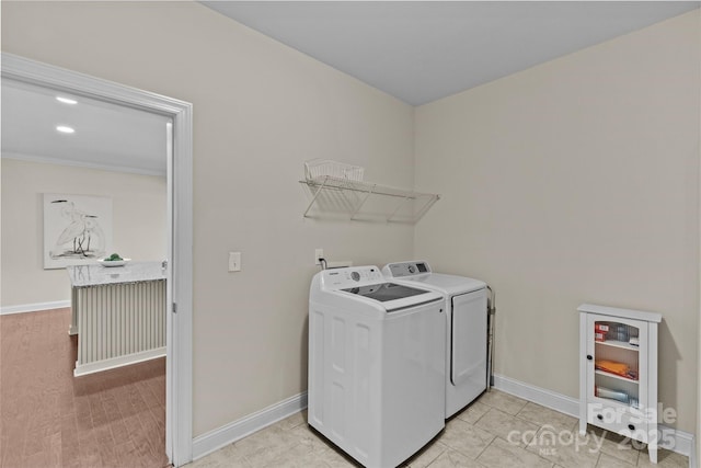 laundry room featuring baseboards, laundry area, and washing machine and clothes dryer