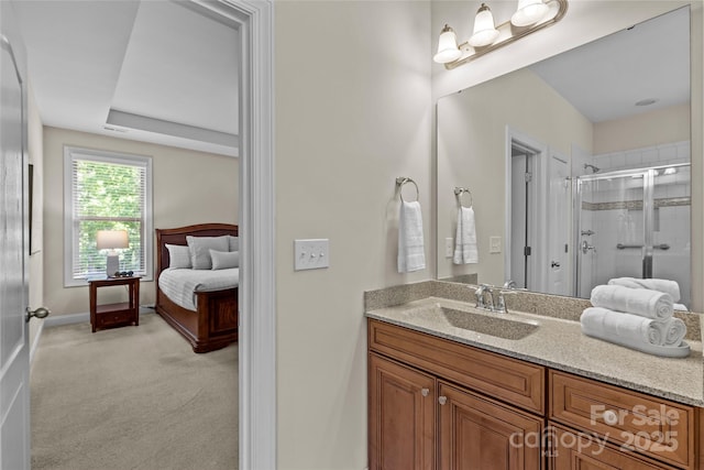 bathroom featuring visible vents, a stall shower, vanity, baseboards, and ensuite bathroom
