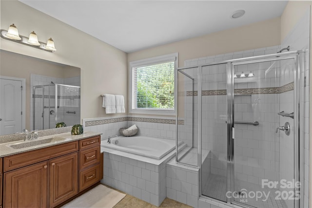 bathroom featuring tile patterned flooring, a shower stall, a bath, and vanity