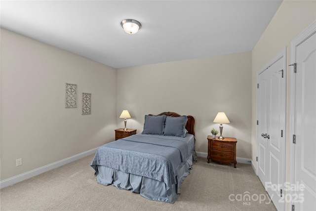 carpeted bedroom featuring baseboards