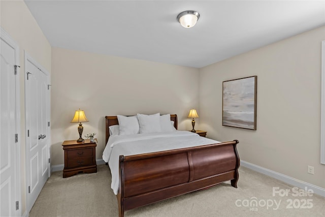 bedroom with baseboards and light carpet