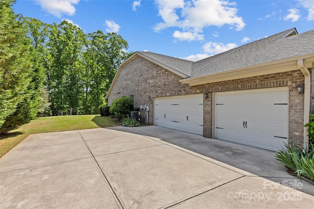 907 Lingfield Ln, Waxhaw, NC 28173 - view of home's exterior featuring roof with shingles, concrete driveway, brick siding, and a yard