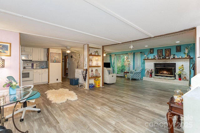 6804 Lineberger Rd, Denver, NC 28037 - living room with light wood-style flooring, a fireplace, and ceiling fan