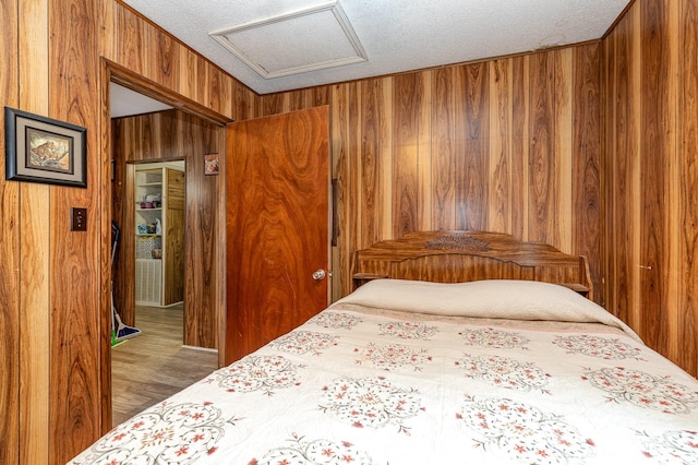 6804 Lineberger Rd, Denver, NC 28037 - bedroom featuring attic access, wooden walls, a textured ceiling, and wood finished floors