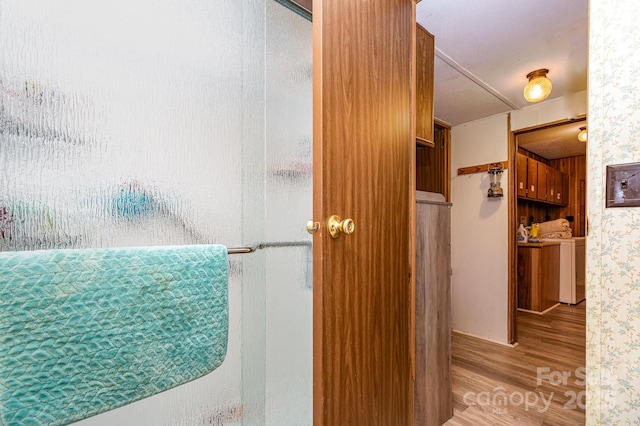 6804 Lineberger Rd, Denver, NC 28037 - full bathroom with wood finished floors, an enclosed shower, and washer and dryer