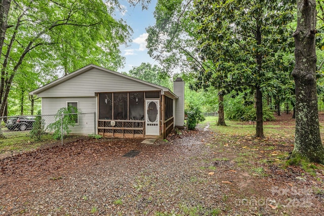 6804 Lineberger Rd, Denver, NC 28037 - back of property with a sunroom, fence, and a chimney