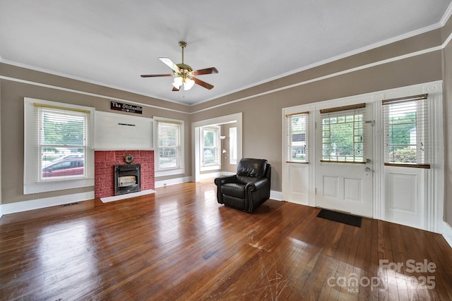 unfurnished living room featuring plenty of natural light, ceiling fan, hardwood / wood-style flooring, and a fireplace