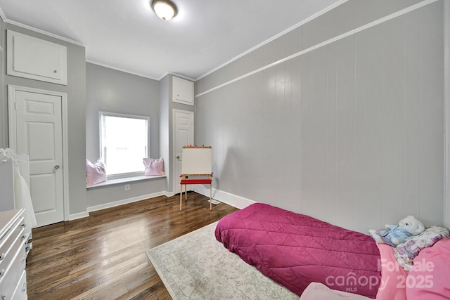 bedroom with crown molding, baseboards, and wood finished floors