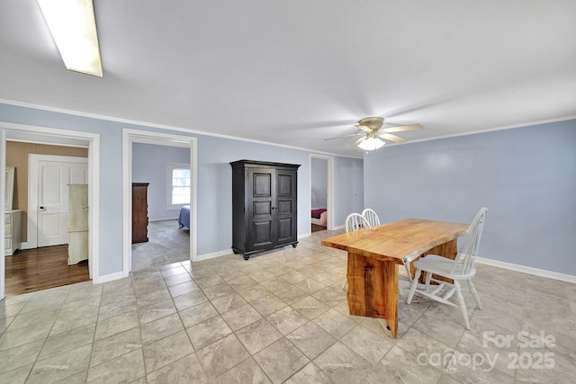 dining room with baseboards, ornamental molding, and a ceiling fan