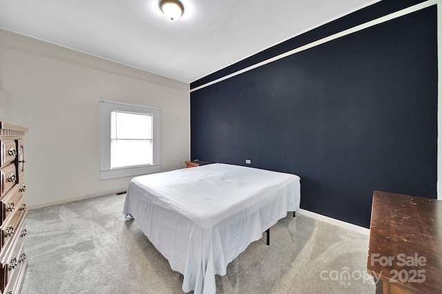 carpeted bedroom featuring baseboards