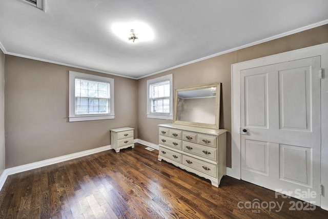 bedroom with baseboards, ornamental molding, dark wood-style floors, and visible vents