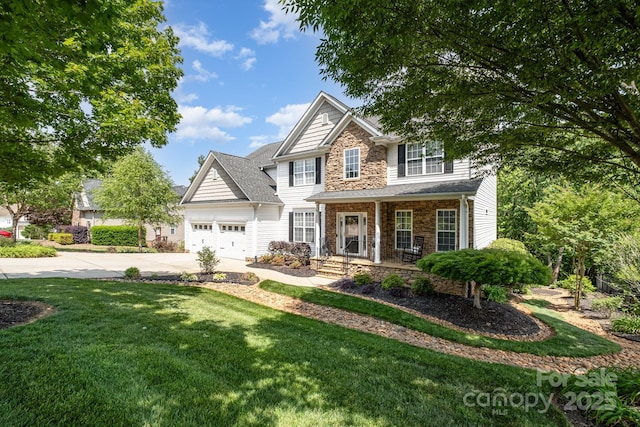 7730 Windsor Forest Pl, Harrisburg, NC 28075 - view of front facade with stone siding, covered porch, an attached garage, concrete driveway, and a front yard