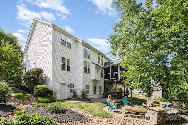 7730 Windsor Forest Pl, Harrisburg, NC 28075 - rear view of property featuring a fire pit, a sunroom, and a patio area