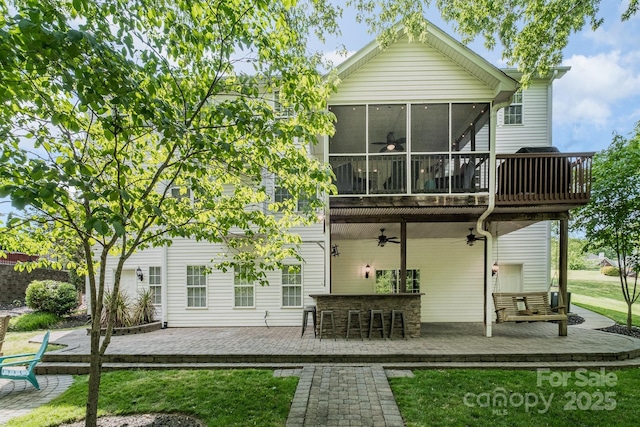 7730 Windsor Forest Pl, Harrisburg, NC 28075 - rear view of house with outdoor dry bar, ceiling fan, a wooden deck, a lawn, and a sunroom