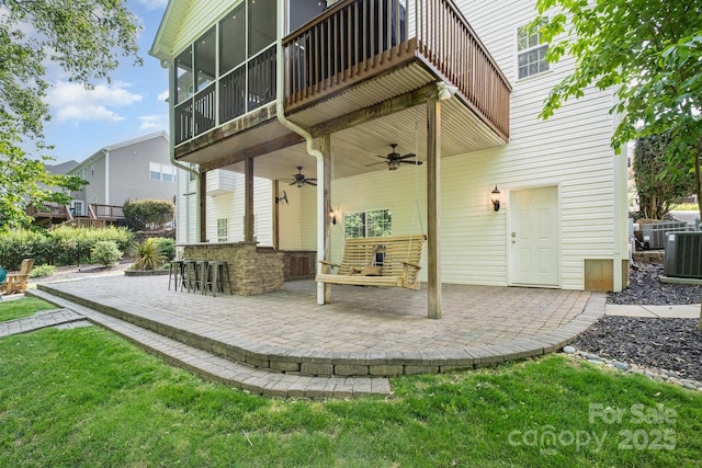 7730 Windsor Forest Pl, Harrisburg, NC 28075 - back of property with outdoor dry bar, central AC, a patio, ceiling fan, and a sunroom
