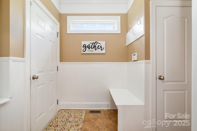 7730 Windsor Forest Pl, Harrisburg, NC 28075 - mudroom featuring tile patterned flooring, a decorative wall, a wainscoted wall, and visible vents