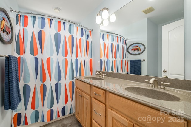 7730 Windsor Forest Pl, Harrisburg, NC 28075 - bathroom featuring a sink, double vanity, visible vents, and tile patterned flooring